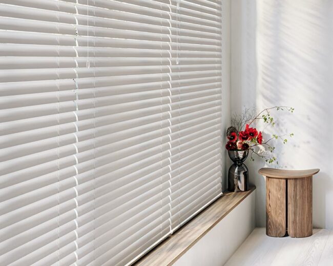 detail of large window covered by Hunter Douglas blinds in a soft white hue