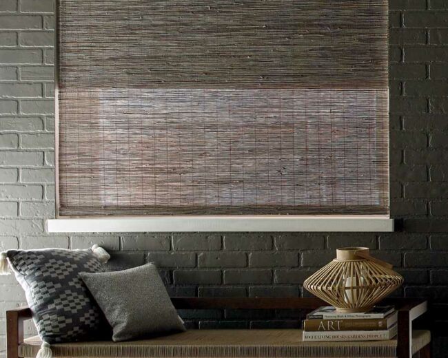 exposed brick wall painted black with coordinating dark brown window treatments