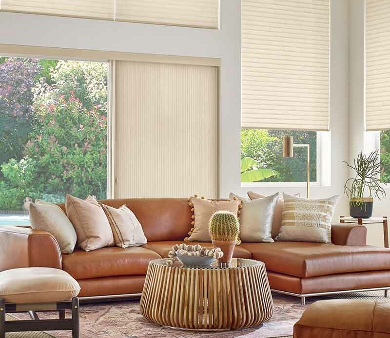 western aesthetic living room with window treatments for sliding glass doors open overlooking pool