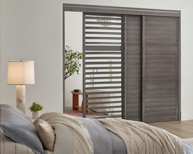 gray wood shutters on sliding glass door for guest bedroom