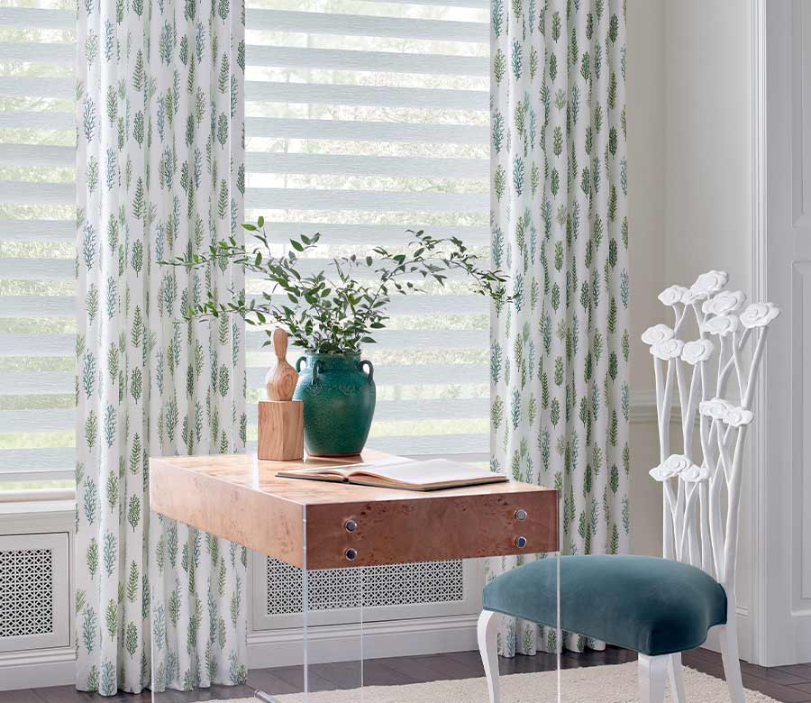 home office with banded dual opacity shades and floor to ceiling custom window treatments with green and blue ferns