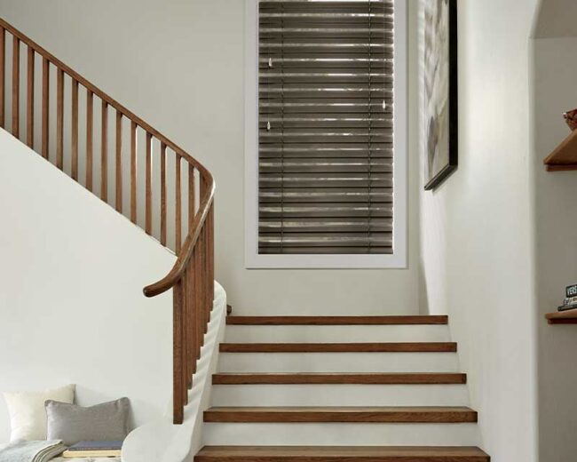 Omaha home's entryway stairs with brown metal blinds
