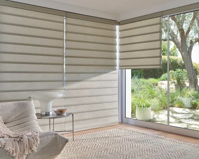 Hunter Douglas olive color window shades floor to ceiling with view through to the outdoor patio for smart home solutions