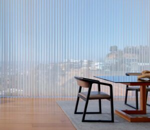 vacation home interior with large windows looking out over hilly skyline