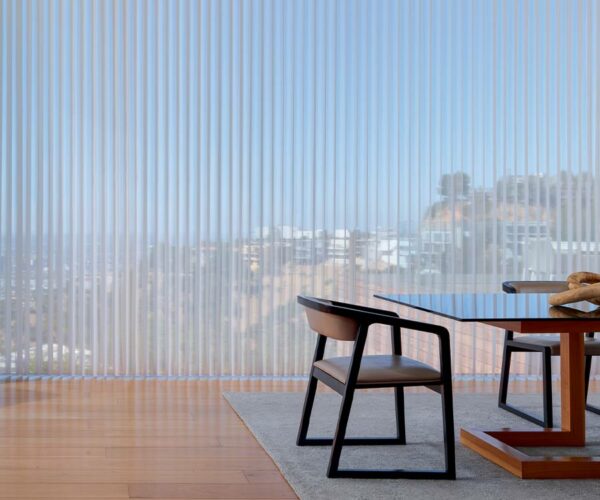 vacation home interior with large windows looking out over hilly skyline