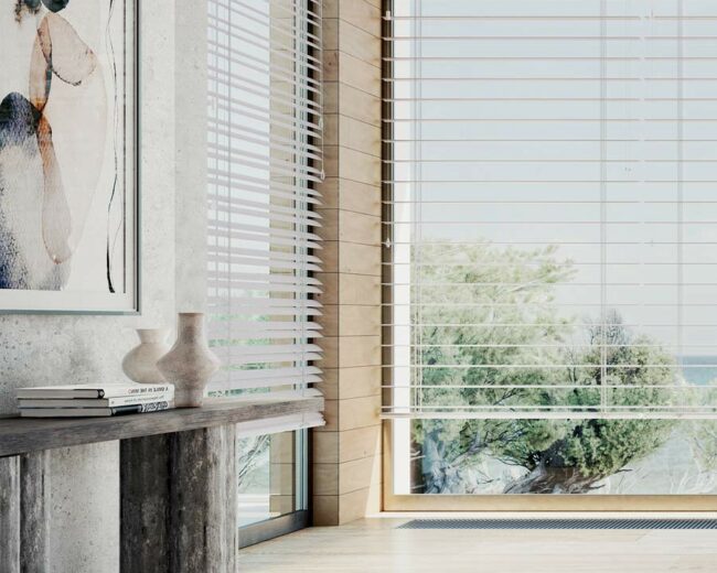 detail of primary bedroom corner windows with white horizontal blinds