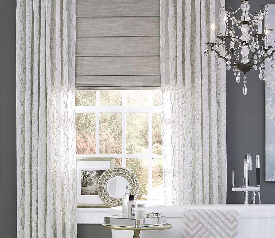 white draperies with soft gray branch pattern and fabric roman shades in Omaha bathroom