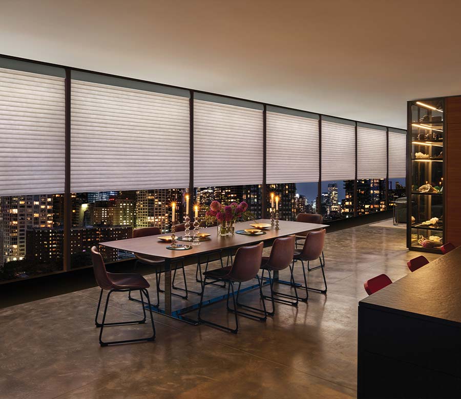 a highrise apartment dining room space with large window shades by hunter douglas