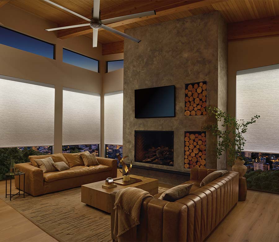 light illuminated window shades in a modern home and leather couches