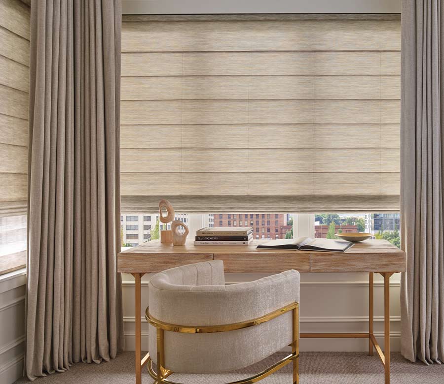 Draperies in home office layered with roman window shades