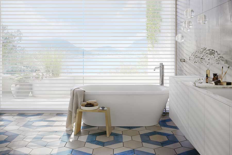 sheer shades on ceiling height windows in master bathroom with blue tile floor